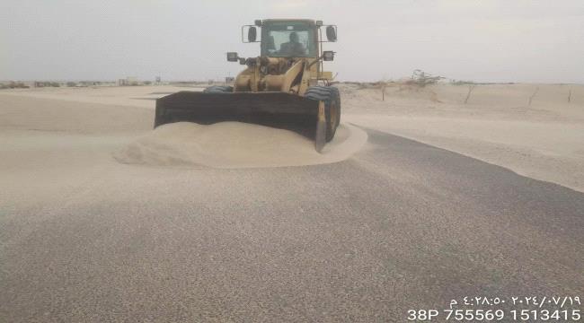 اخبار وتقارير – مؤسسة الطرق بشبوة تواصل إزاحة الرمال عن الطريق الدولي